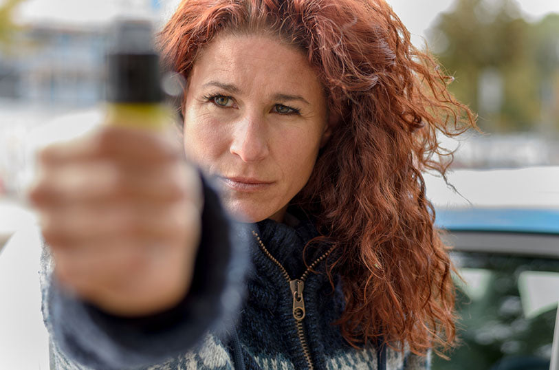 closeup view woman holding pepper spray