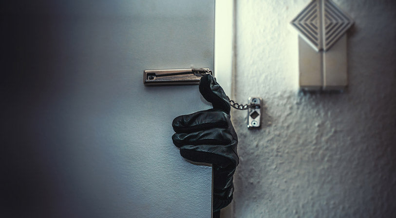 masked burglar with a crowbar