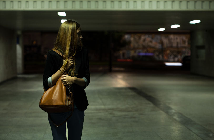 woman holding purse in parking garage